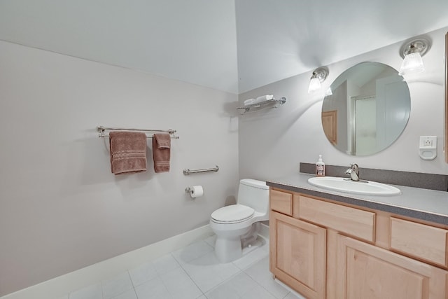 bathroom featuring tile flooring, toilet, and large vanity