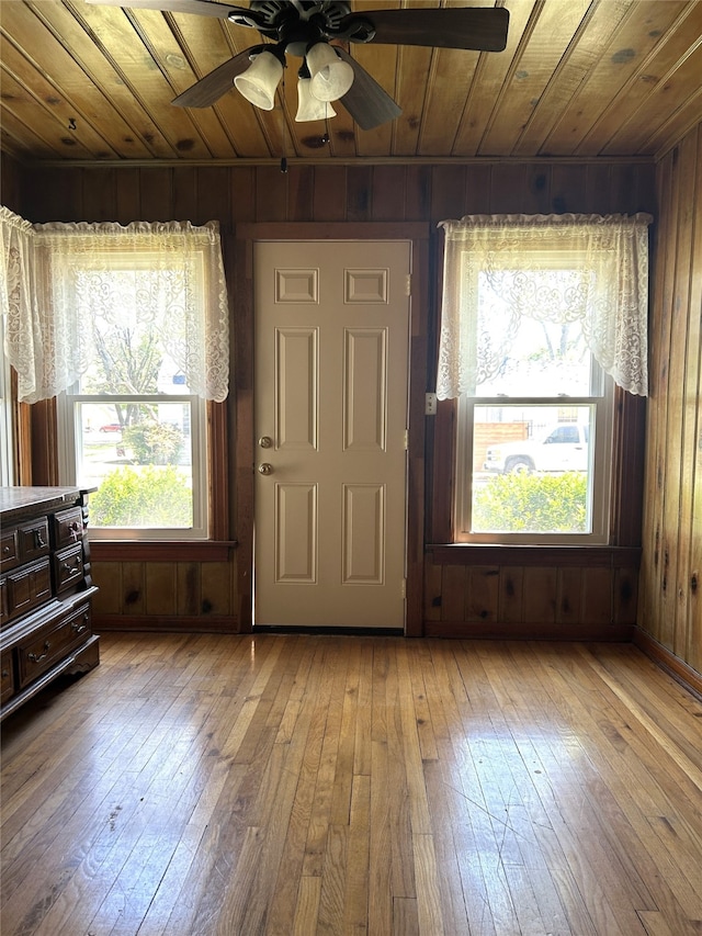 entrance foyer with ceiling fan, hardwood / wood-style flooring, wooden walls, and wood ceiling