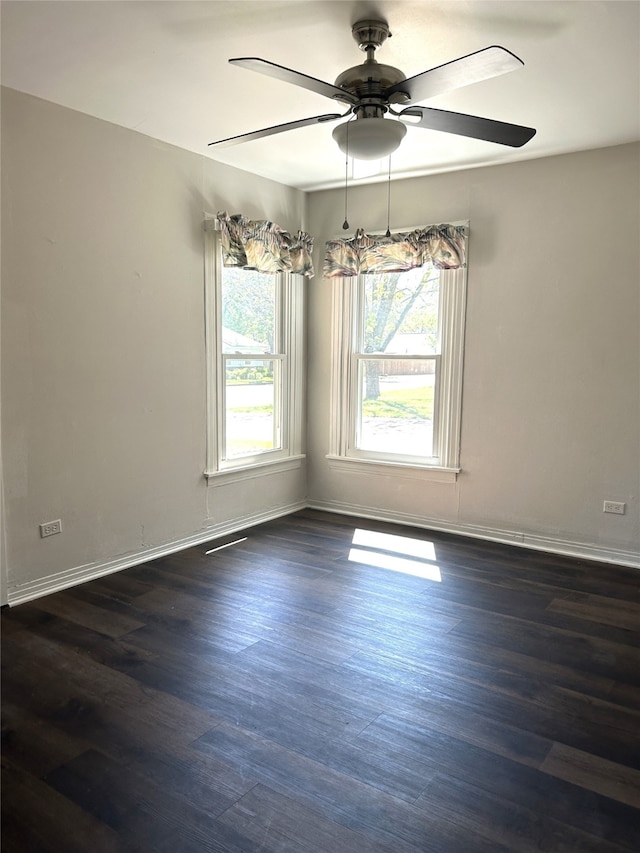 spare room with ceiling fan and dark hardwood / wood-style floors