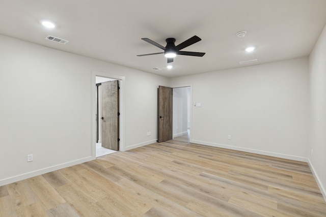 empty room featuring ceiling fan and light wood-type flooring