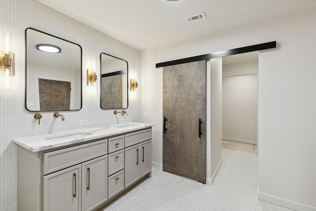 bathroom featuring tasteful backsplash, vanity, and tile walls