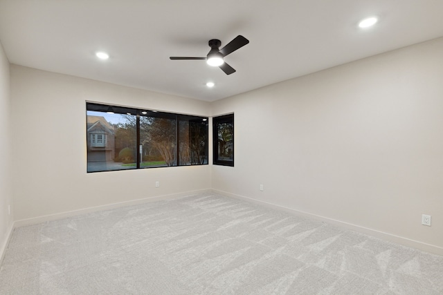 unfurnished room with ceiling fan and light colored carpet