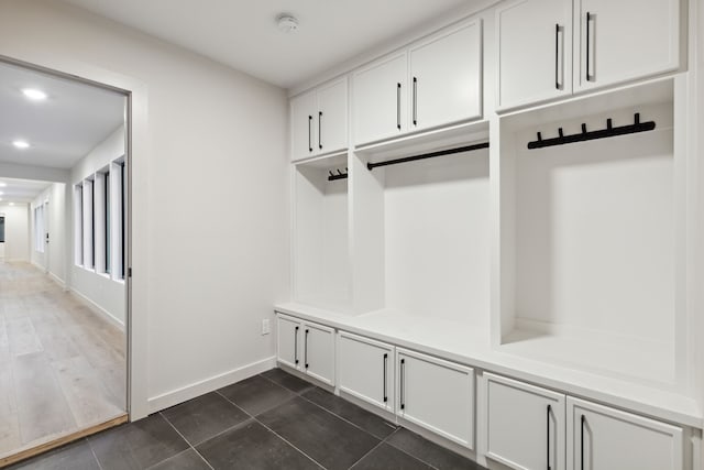 mudroom with dark tile patterned flooring