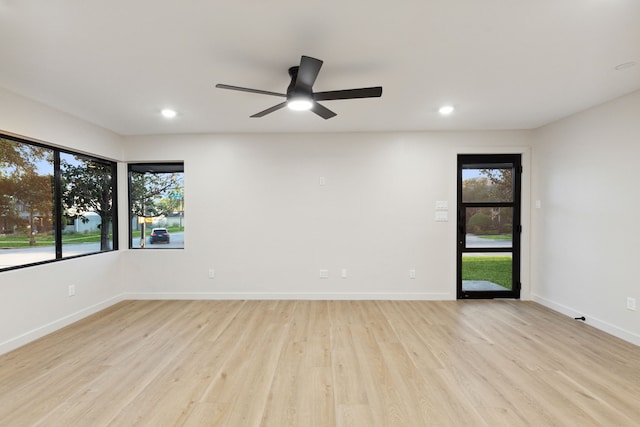 spare room featuring ceiling fan and light hardwood / wood-style flooring