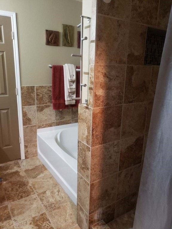 bathroom with tile flooring and plus walk in shower