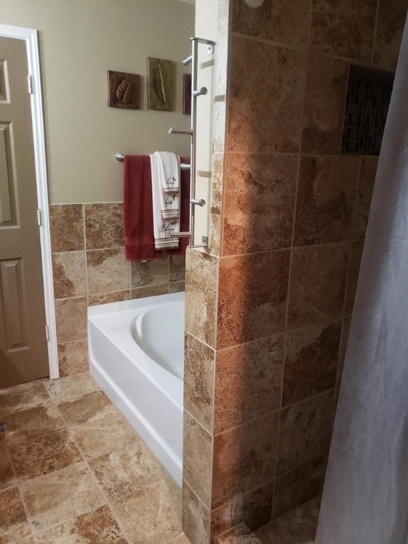 bathroom with tile walls, tile floors, and independent shower and bath