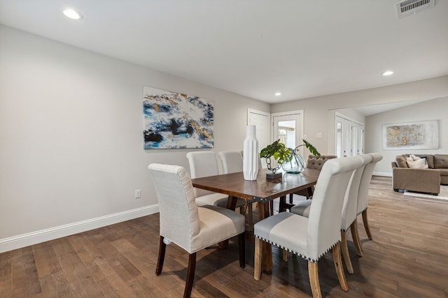 dining space with wood-type flooring