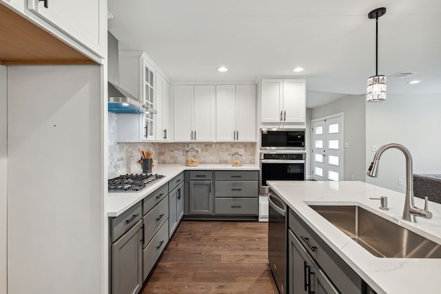 kitchen with white cabinetry, dark wood-type flooring, gray cabinets, stainless steel appliances, and sink