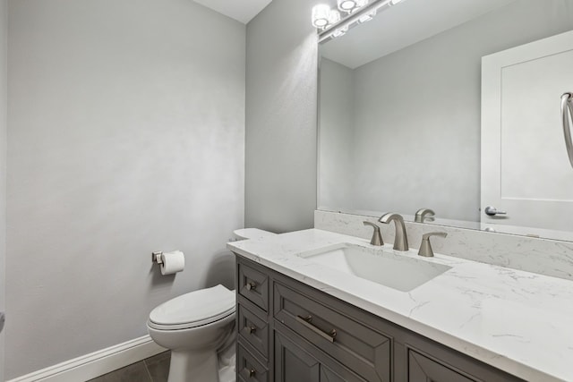 bathroom with vanity, tile patterned floors, and toilet