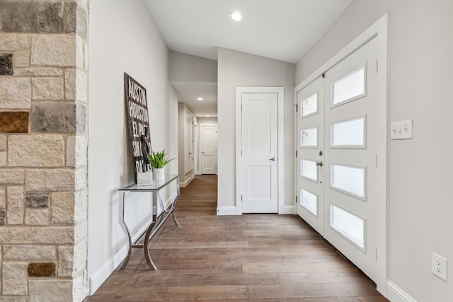 entrance foyer with lofted ceiling, baseboards, wood finished floors, and recessed lighting