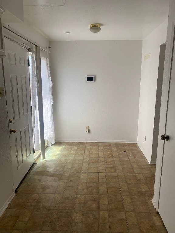 empty room with dark tile flooring