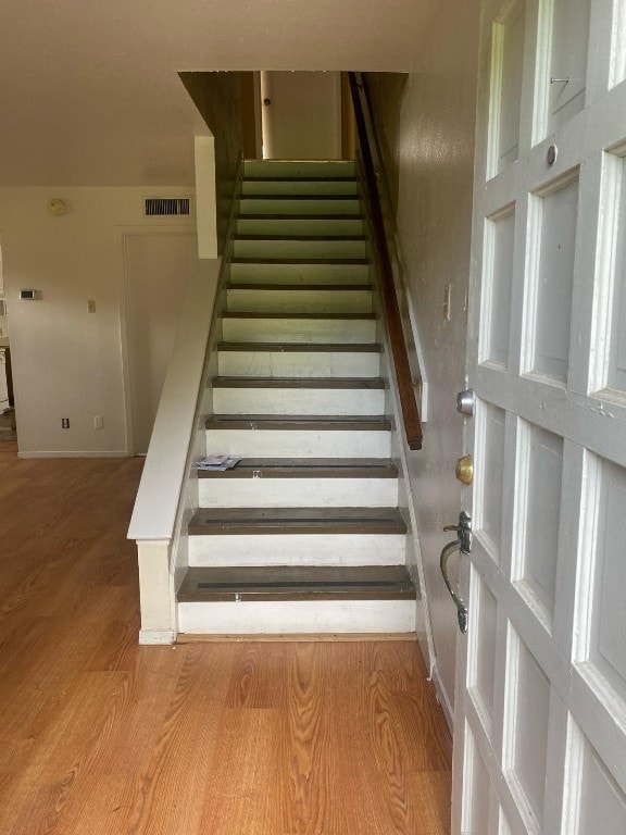 staircase with light wood-type flooring