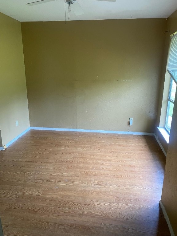 empty room with wood-type flooring and ceiling fan