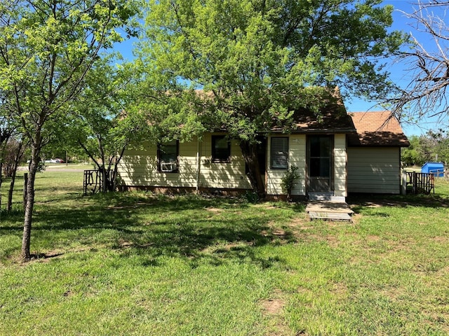 back of house with a lawn