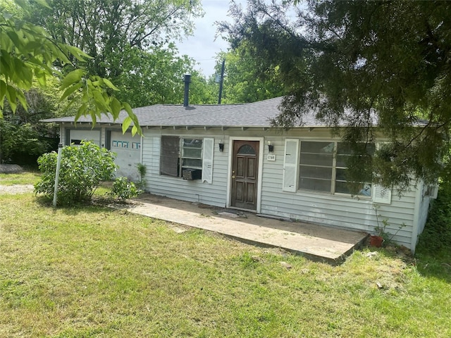 back of house with a lawn