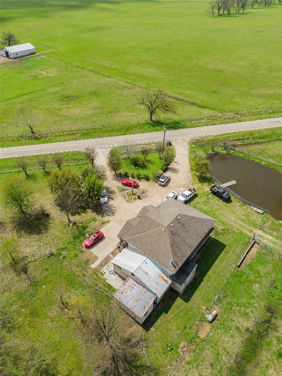 birds eye view of property featuring a rural view and a water view