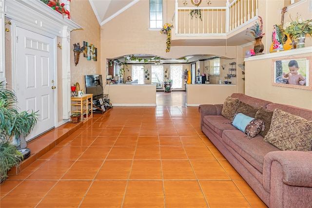 living room featuring high vaulted ceiling and light tile floors