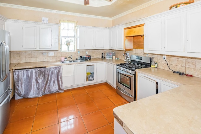 kitchen featuring appliances with stainless steel finishes, white cabinetry, crown molding, backsplash, and sink