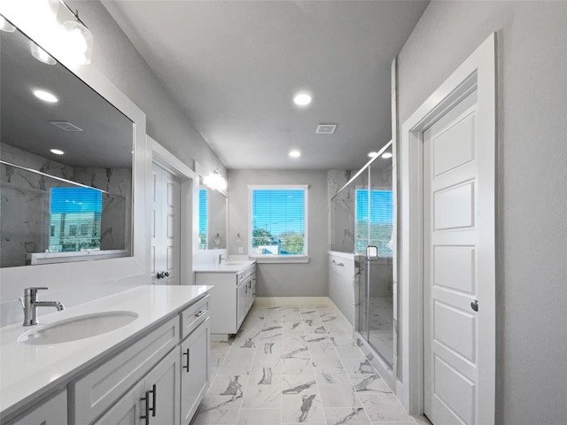 bathroom with a shower with door, double sink, tile floors, and vanity with extensive cabinet space