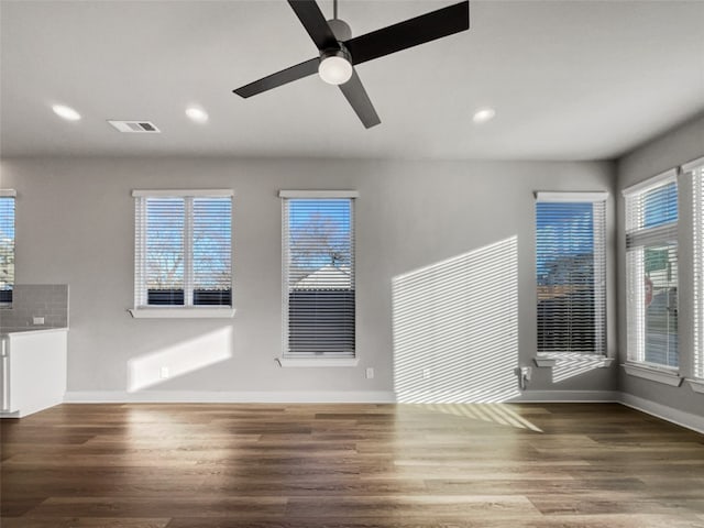 interior space featuring plenty of natural light, dark hardwood / wood-style flooring, and ceiling fan