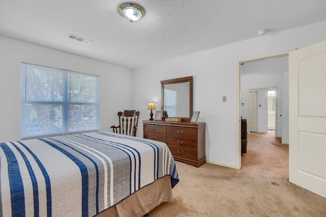 carpeted bedroom featuring a textured ceiling