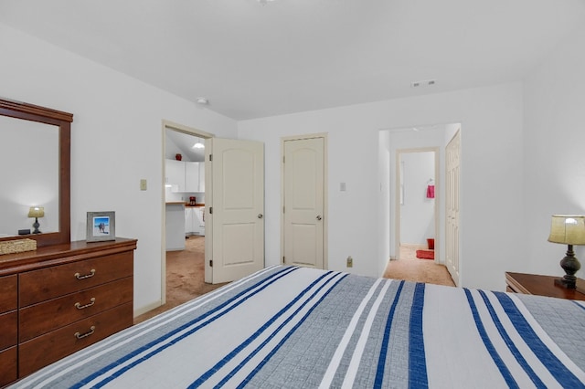 bedroom with light colored carpet and a closet