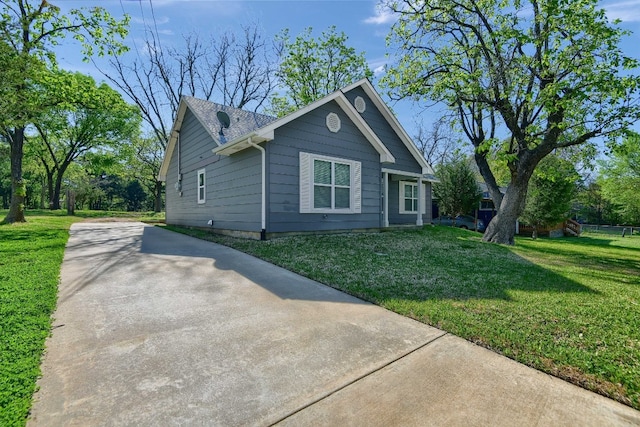 view of side of home with a yard