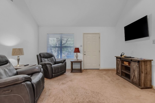 carpeted living room with vaulted ceiling