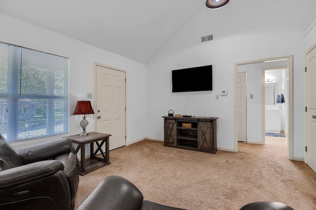 carpeted living room featuring vaulted ceiling