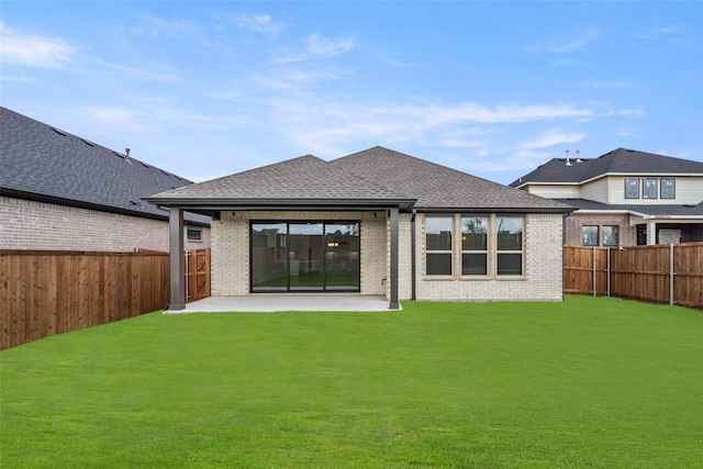 rear view of house featuring a patio and a lawn