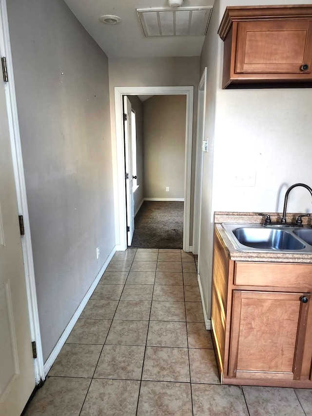 kitchen with sink and light tile patterned flooring