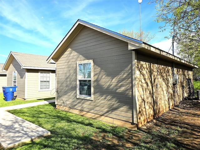 view of side of home featuring a yard