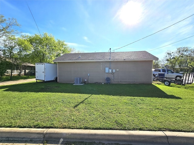 back of property featuring a yard and central air condition unit