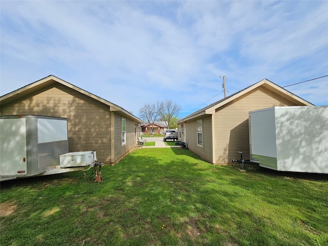 view of side of property featuring a yard