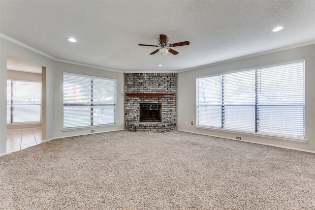 unfurnished living room with light carpet, a brick fireplace, ceiling fan, and a textured ceiling