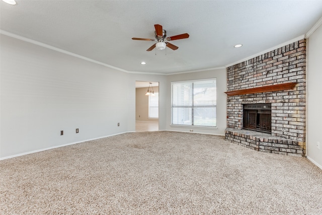 unfurnished living room featuring carpet flooring, ornamental molding, ceiling fan, and a fireplace