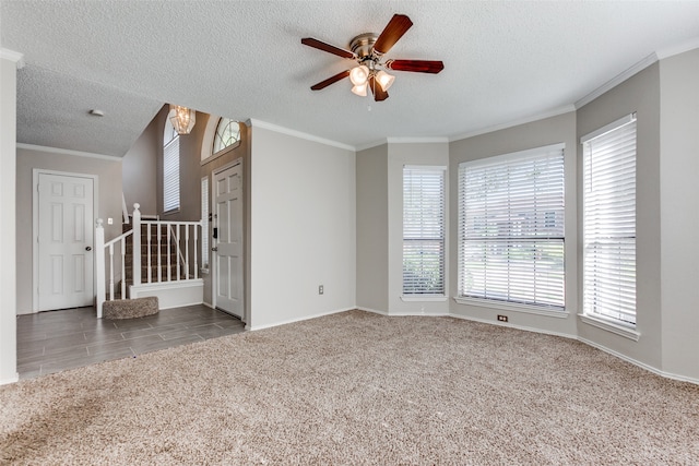 unfurnished living room featuring ceiling fan, crown molding, carpet flooring, and a textured ceiling