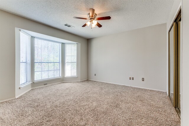 interior space with ceiling fan and a textured ceiling