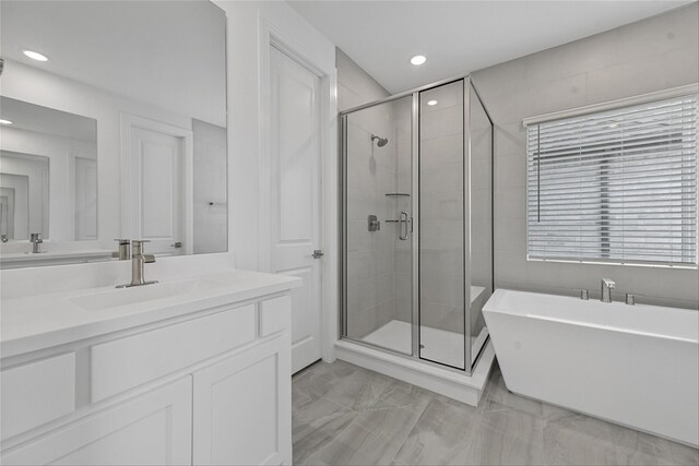 bathroom featuring vanity and plus walk in shower