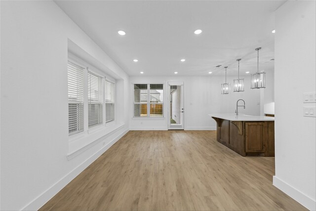 interior space with sink and light hardwood / wood-style floors