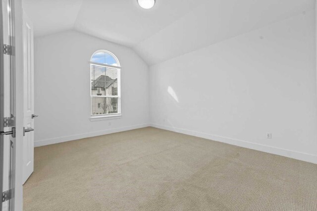 interior space with lofted ceiling and light colored carpet