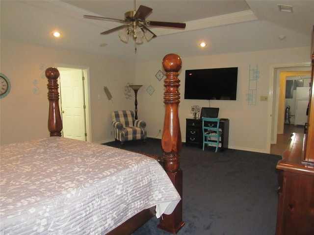 bedroom featuring ceiling fan, white refrigerator, and a raised ceiling