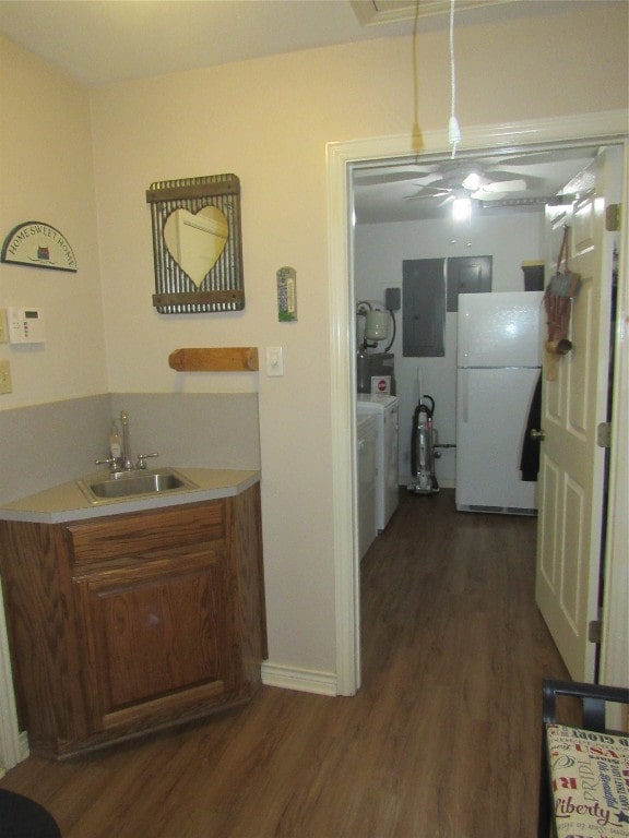 bathroom with sink, washer / dryer, and hardwood / wood-style flooring