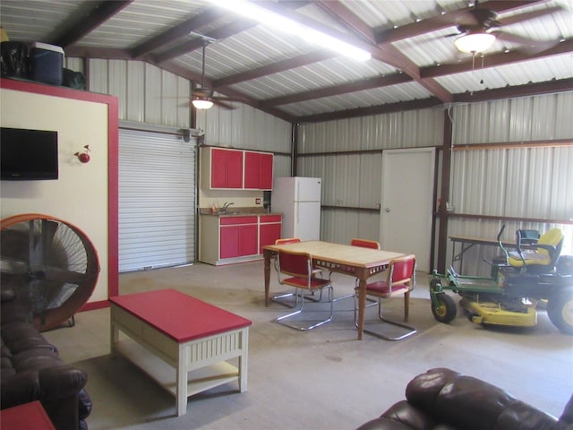 garage featuring ceiling fan, white refrigerator, and sink