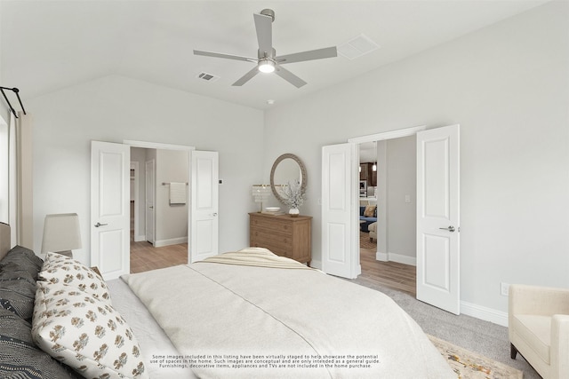 carpeted bedroom with ceiling fan and vaulted ceiling