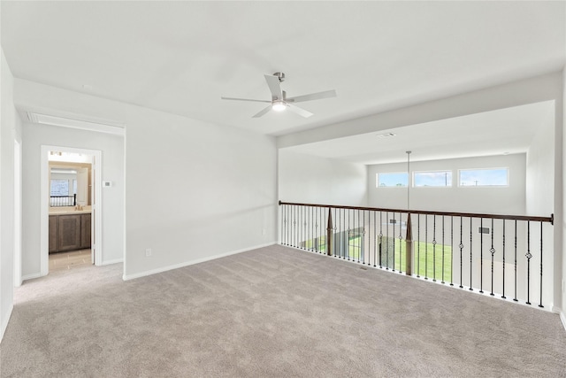 carpeted empty room featuring ceiling fan