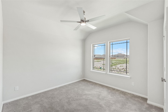 carpeted spare room with ceiling fan and lofted ceiling