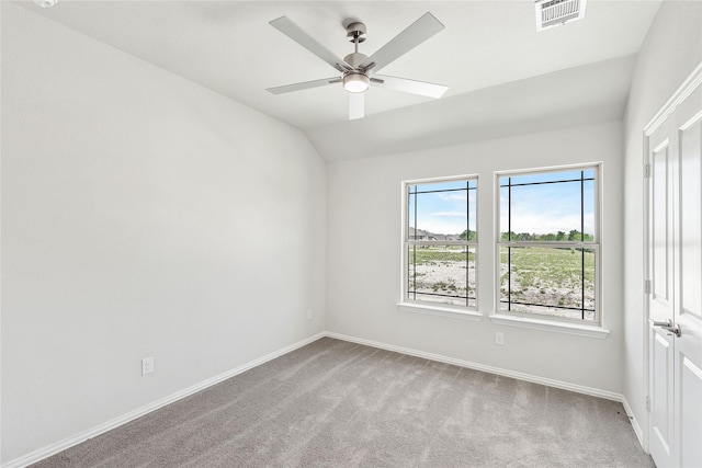 empty room featuring light carpet, ceiling fan, and lofted ceiling