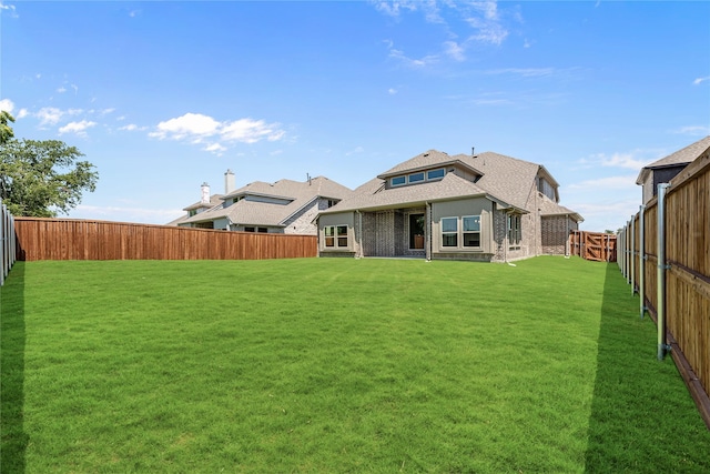 back of house featuring a yard