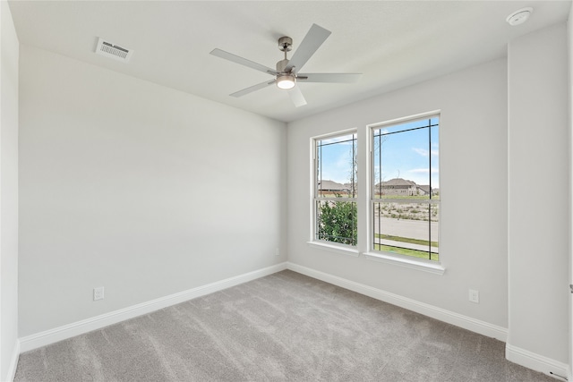 carpeted empty room featuring ceiling fan